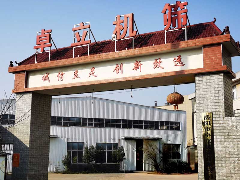 Front-exterior-view-of-the-modern-industrial-facility,-specializing-in-agricultural-machinery-parts.